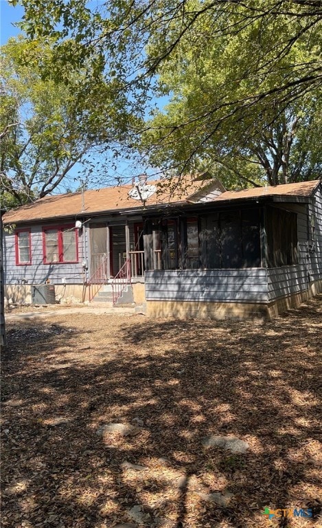 view of front of property featuring a sunroom