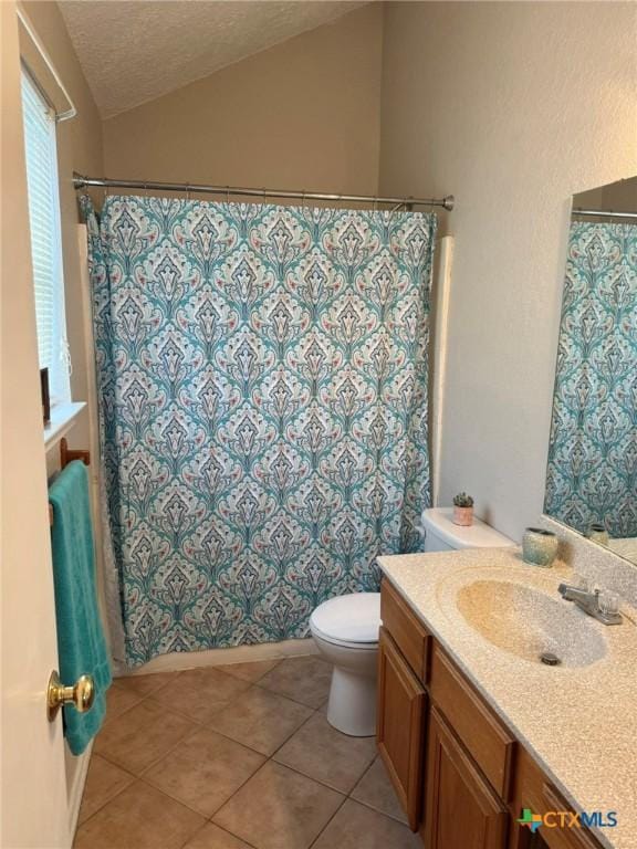 2301 Flintstone Cir, Killeen, TX 76543 - bathroom with vanity, tile patterned flooring, vaulted ceiling, a textured ceiling, and a shower with shower curtain