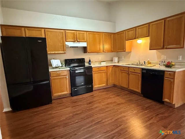 2301 Flintstone Cir, Killeen, TX 76543 - kitchen featuring black appliances, under cabinet range hood, a high ceiling, light countertops, and dark wood-type flooring