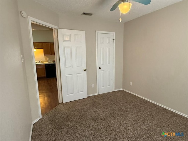 2301 Flintstone Cir, Killeen, TX 76543 - unfurnished bedroom featuring carpet floors, ceiling fan, and a textured ceiling