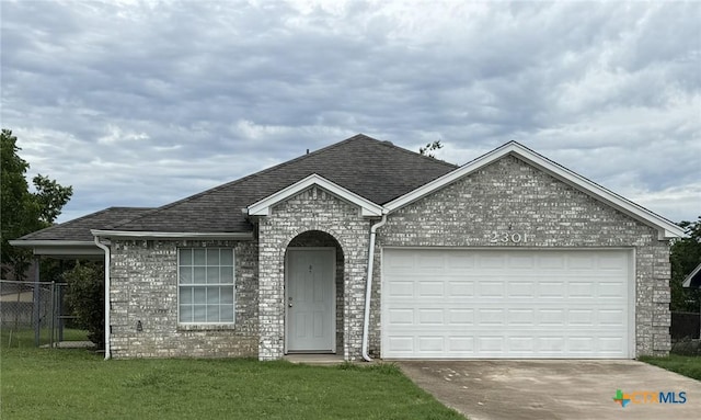 2301 Flintstone Cir, Killeen, TX 76543 - view of front of home with concrete driveway, brick siding, an attached garage, and roof with shingles