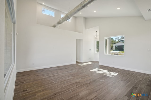 3006 Dew Drop, Horseshoe Bay, TX 78657 - unfurnished room featuring wood finished floors, baseboards, high vaulted ceiling, and recessed lighting