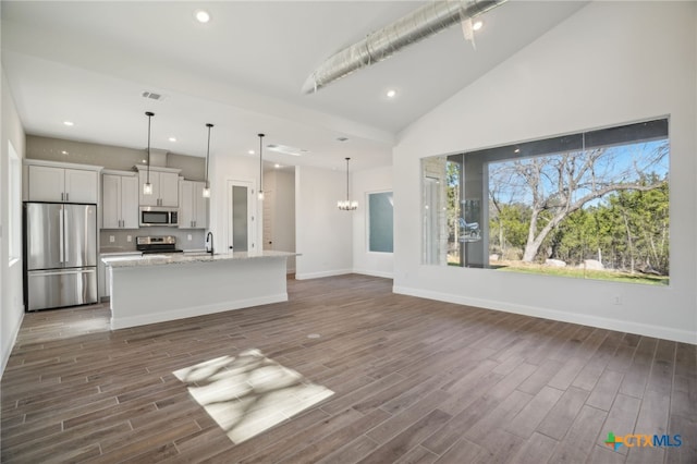 3006 Dew Drop, Horseshoe Bay, TX 78657 - kitchen featuring appliances with stainless steel finishes, a center island with sink, dark wood-type flooring, baseboards, and recessed lighting