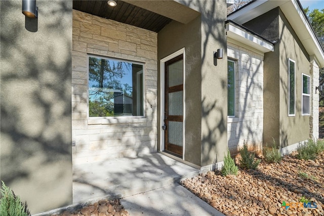 3006 Dew Drop, Horseshoe Bay, TX 78657 - entrance to property featuring stucco siding and stone siding