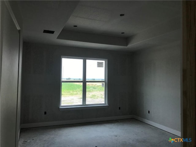 18045 Round Hall Rd, Holland, TX 76534 - unfurnished room with a tray ceiling and baseboards