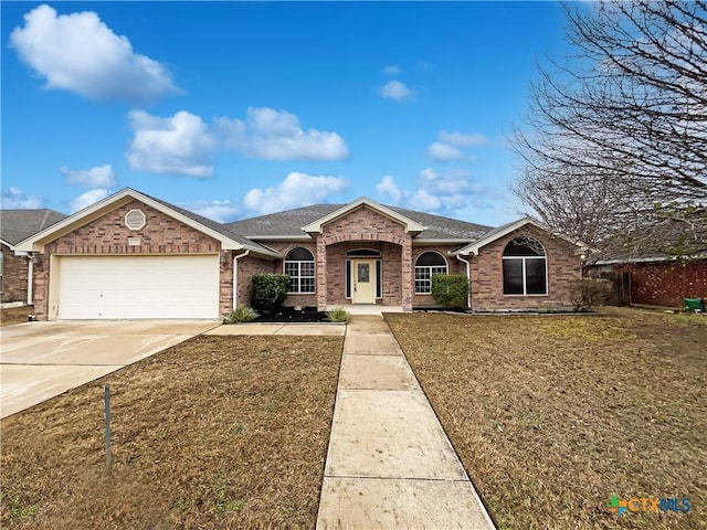 ranch-style house featuring a garage and a front lawn