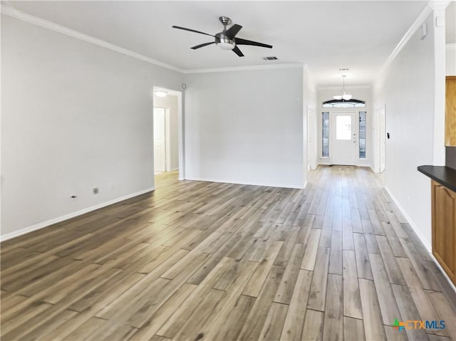 unfurnished living room featuring hardwood / wood-style floors, ceiling fan, and crown molding