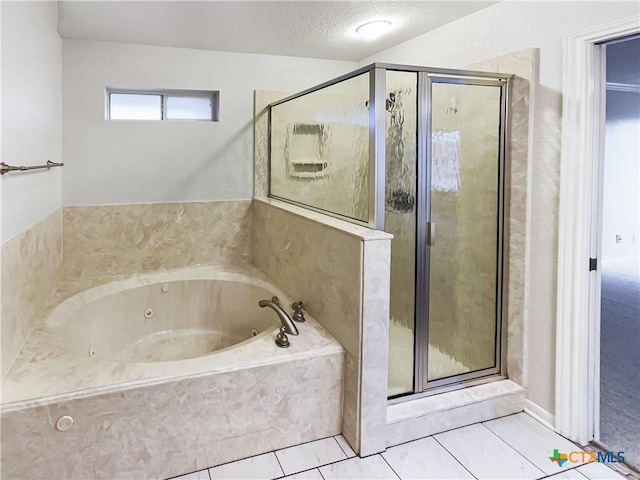 bathroom featuring tile patterned flooring, shower with separate bathtub, and a textured ceiling