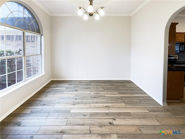 unfurnished dining area featuring light hardwood / wood-style flooring, a chandelier, and ornamental molding