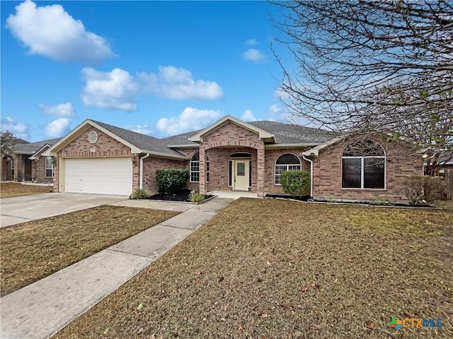 single story home featuring a front lawn and a garage