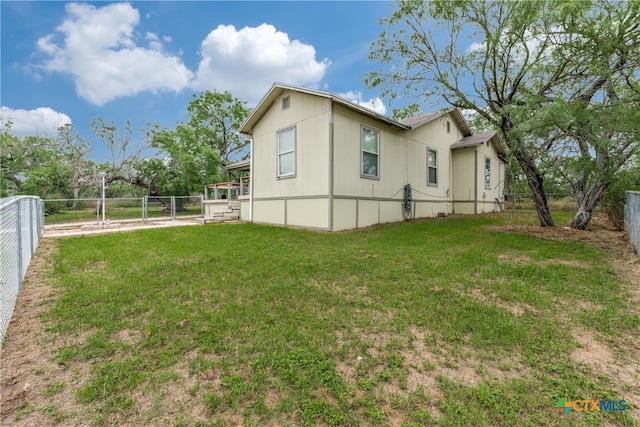 view of side of home with a lawn