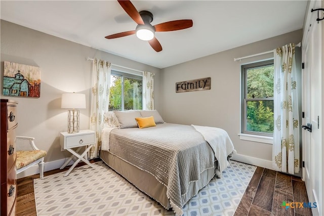 bedroom with multiple windows and ceiling fan