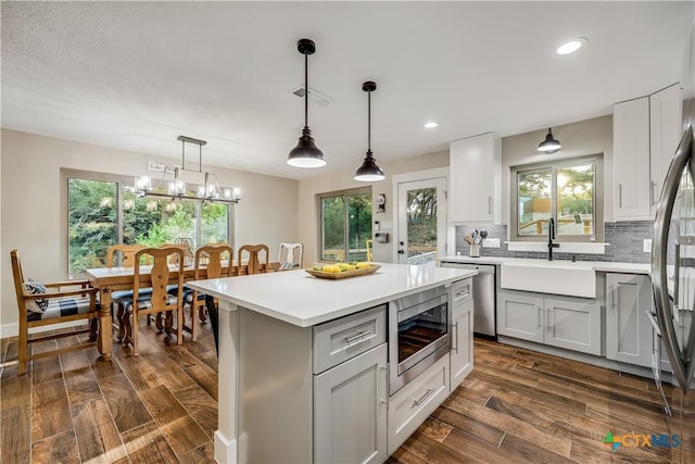 kitchen featuring pendant lighting, sink, stainless steel appliances, and tasteful backsplash