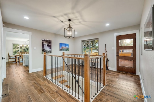 hall with plenty of natural light and a notable chandelier