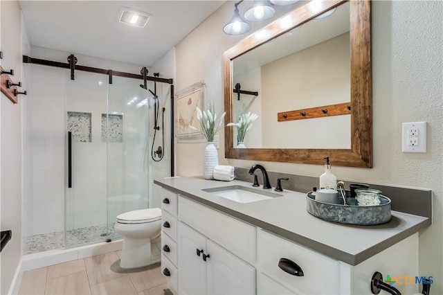 bathroom with tile patterned floors, vanity, toilet, and an enclosed shower