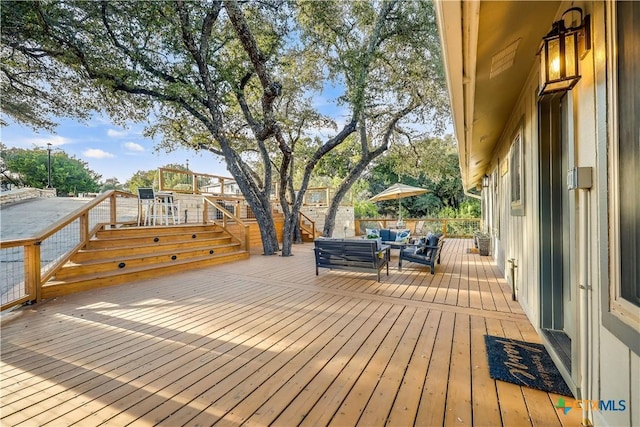 wooden deck with an outdoor living space