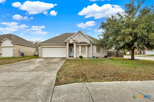 view of front of home with a front lawn and a garage