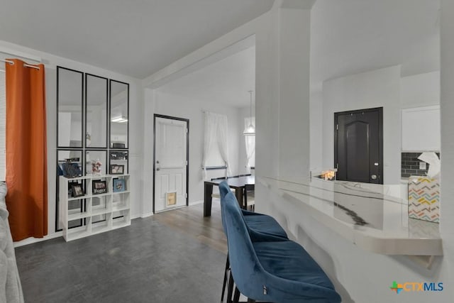 kitchen featuring light stone countertops and kitchen peninsula