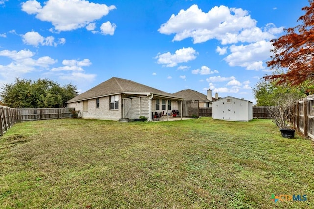 view of yard featuring a patio area and a storage unit