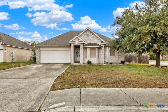 view of front facade with a front yard and a garage