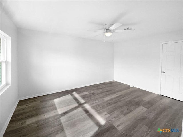 spare room with ceiling fan and dark hardwood / wood-style flooring