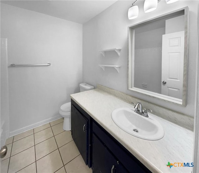 bathroom with vanity, tile patterned floors, and toilet