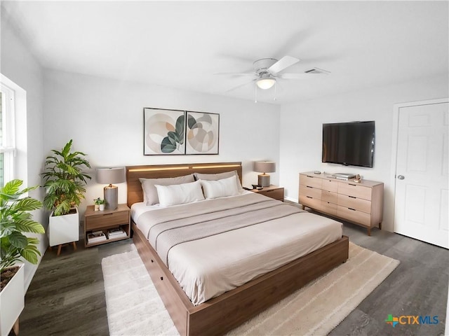 bedroom featuring ceiling fan and dark hardwood / wood-style floors