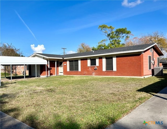 ranch-style house with a front lawn, central AC unit, and a carport