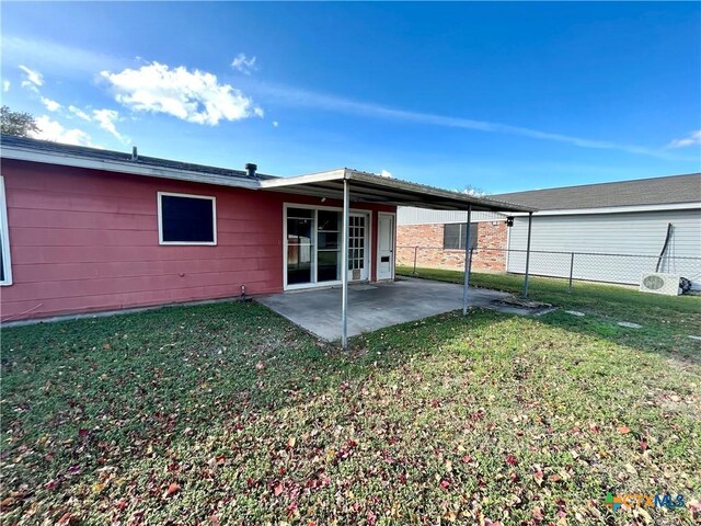 rear view of property with a yard and a patio