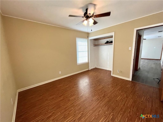 unfurnished bedroom with a closet, dark hardwood / wood-style floors, and ceiling fan