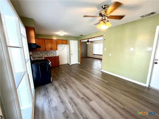 kitchen featuring ceiling fan, black electric range, ventilation hood, decorative backsplash, and light wood-type flooring