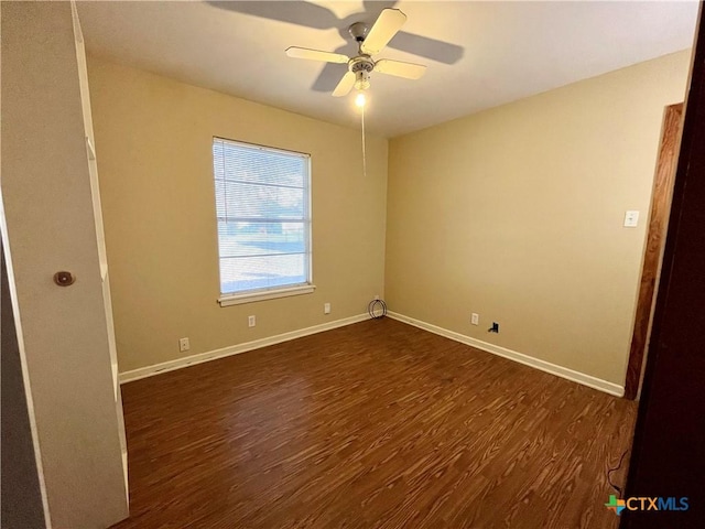 empty room with dark hardwood / wood-style flooring and ceiling fan