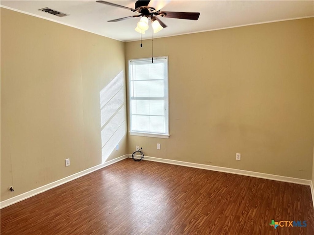 unfurnished room featuring ceiling fan, dark wood-type flooring, and ornamental molding