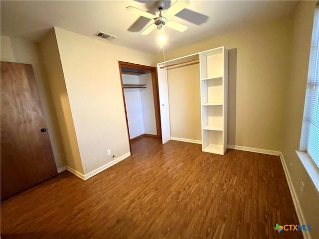 unfurnished bedroom featuring ceiling fan and dark hardwood / wood-style flooring