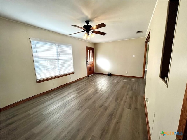 empty room with ceiling fan and dark wood-type flooring