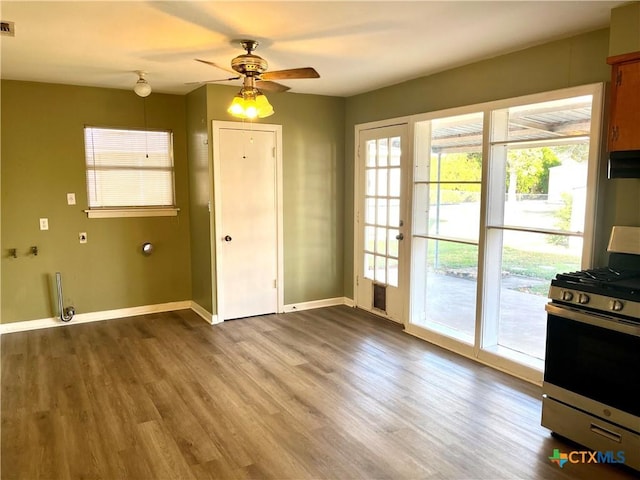 interior space with ceiling fan and wood-type flooring