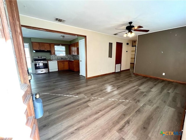 unfurnished living room with dark hardwood / wood-style floors and ceiling fan