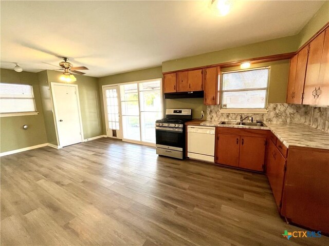 kitchen featuring ceiling fan, sink, light hardwood / wood-style flooring, dishwasher, and stainless steel range with gas cooktop