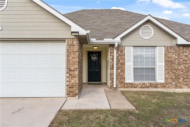 doorway to property with a lawn and a garage