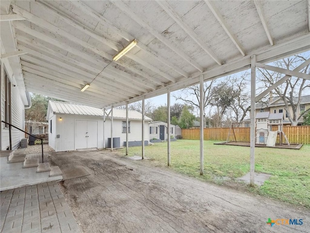 exterior space featuring a shed, a lawn, a patio, and a playground