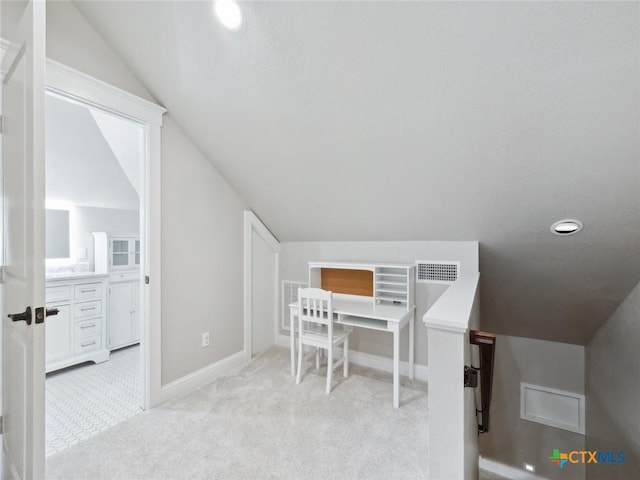 interior space featuring lofted ceiling and light colored carpet