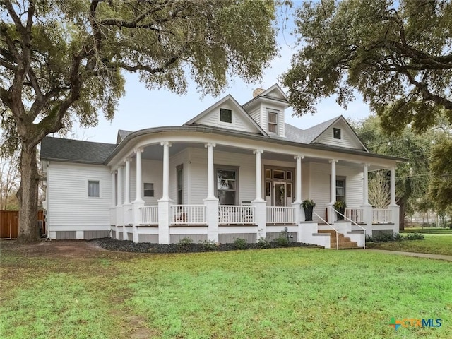 farmhouse inspired home featuring covered porch and a front lawn