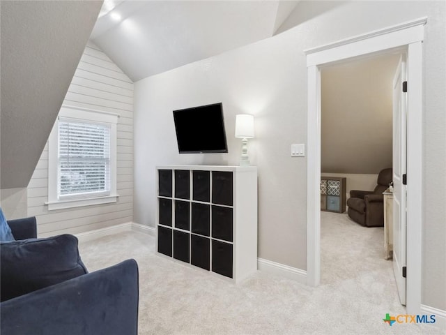 carpeted living room with vaulted ceiling