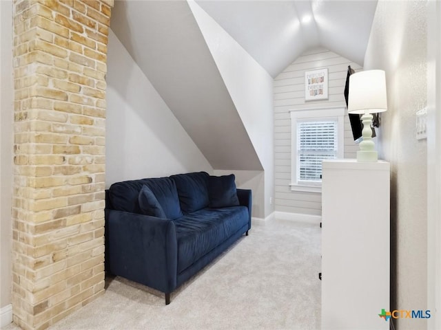 living room featuring lofted ceiling and carpet floors