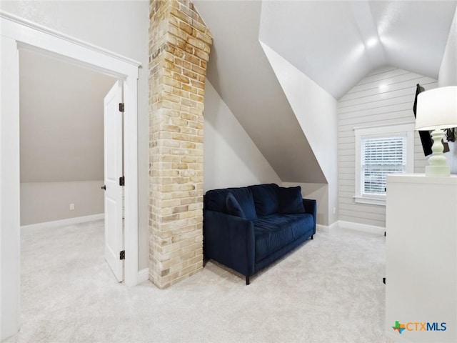 sitting room with vaulted ceiling and light colored carpet