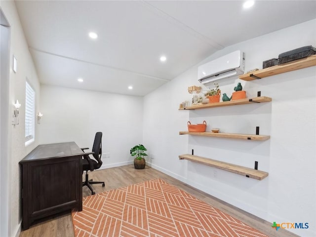 home office featuring wood-type flooring, lofted ceiling, and a wall unit AC