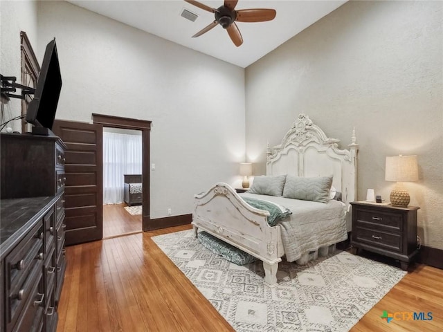 bedroom featuring ceiling fan, wood-type flooring, and access to exterior