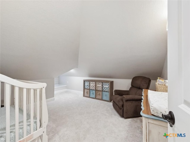 bedroom with lofted ceiling and light colored carpet