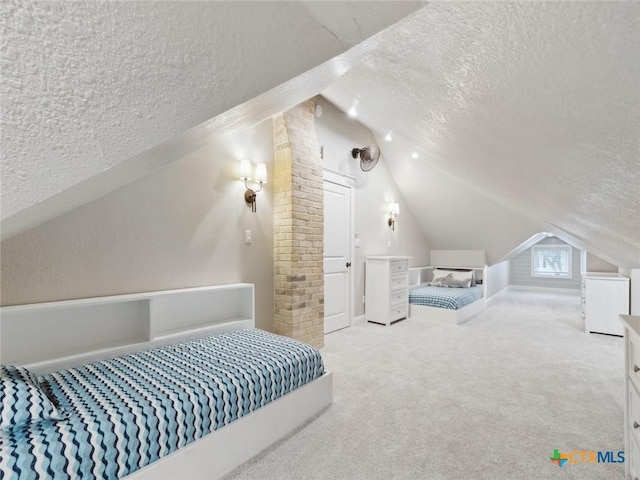 carpeted bedroom with vaulted ceiling and a textured ceiling