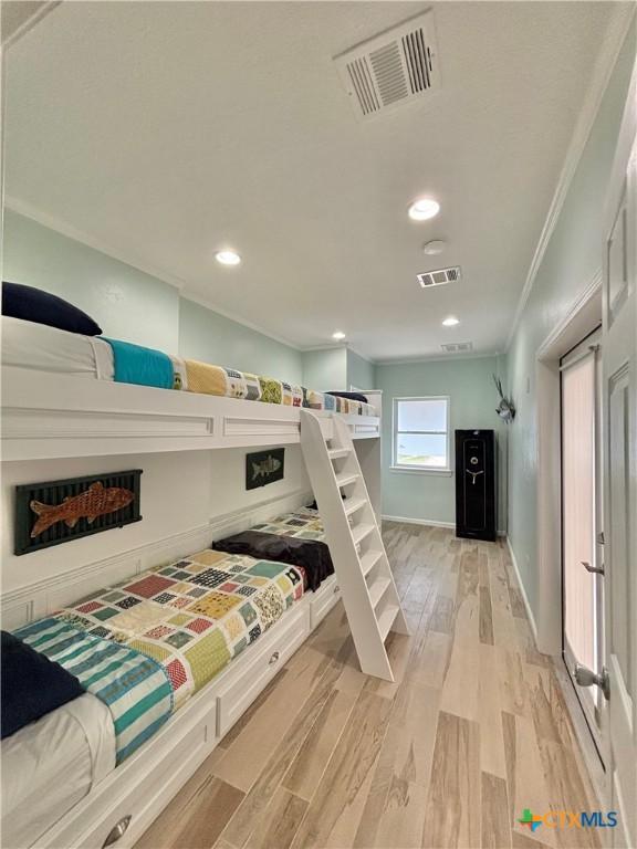 bedroom featuring light wood finished floors, recessed lighting, visible vents, and crown molding